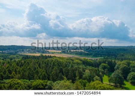 Panorama of countryside, forest , field and fluffy clouds, nature background