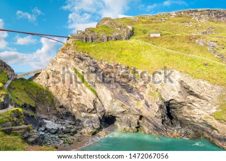 View to Tintagel island, legendary Tintagel castle ruins and Merlin's cave. Royalty-Free Stock Photo #1472067056