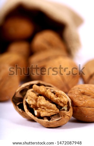 Whole and cracked walnuts in different backgrounds 