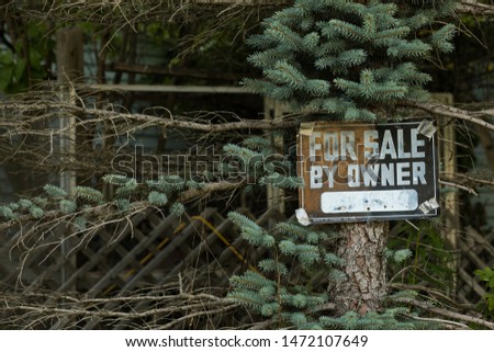 'for sale by owner' wood sigh on tree