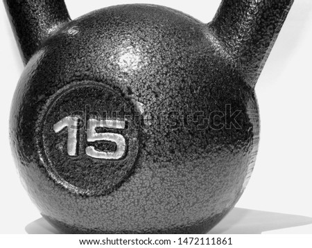 A black and white photo of a 15-pound kettlebell.
