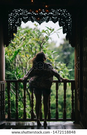 A female model under tropical summer rain at Phuket Thailand, Koh Yao Yai Island