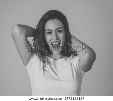 Portrait of Amazed excited woman with red curly hair dancing and making overjoy gestures in Happy face facial expression, Positive Human emotions and happiness. Isolated on grey background.