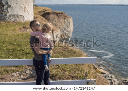 Father and daughter enjoy a view on the cliffs.