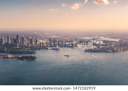 Aerial view of Sydney Harbour with Sydney Harbour Bridge and Central Business District. Tourism Australia
