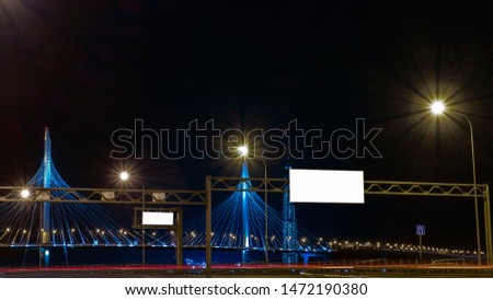Banner on the night highway with a beautiful view of the bridge and the city. Royalty-Free Stock Photo #1472190380