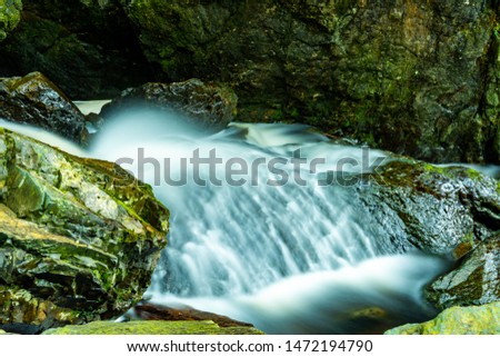 Dynamic water running over a stone step in a stream in nicely long exposed picture