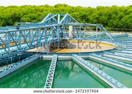 Water treatment,the process of making raw water to clean by putting chemicals in the machines,processing of the solid contact clarifier sediment tank.Wastewater Treatment Plant with steel structure. Royalty-Free Stock Photo #1472197964