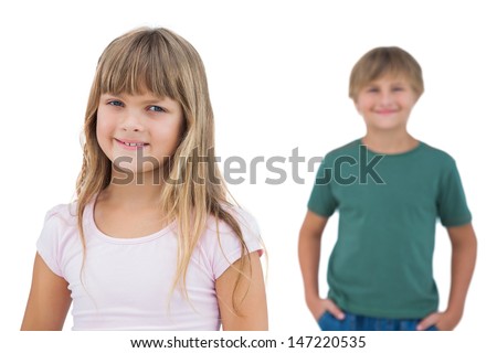 Girl smiling with boy behind her on white background 