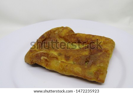 Eat indonesian traditional snack cake street market or gorengan or fried martabak telur telor mini small. filled with carrot,corn,celery fritter, acar, cook homemade. Oil oily texture. Square shape
