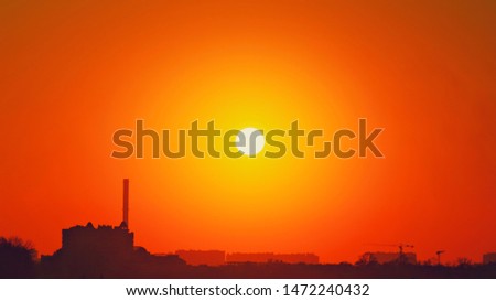 Heatwave hot sun. Global warming llimate change. Summer background with a magnificent summer sun. Autumn sunset. The setting sun in a clear sky. Hot city weather concept. High temperature at summer Royalty-Free Stock Photo #1472240432