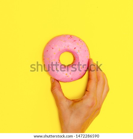 Sweet Donut on a yellow background. Flat lay fast food art. Donuts lover concept