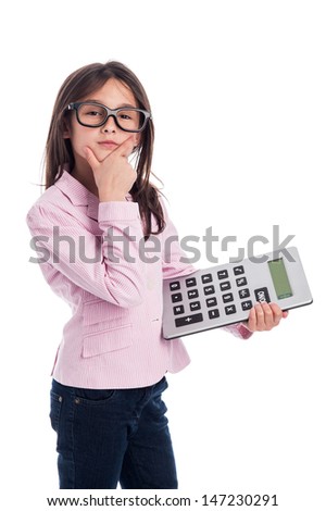 Clever girl with glasses and a calculator doing a calculation. Isolated on a studio white background.