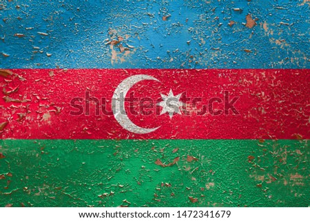 National flag of Azerbaijan on old peeling wall background.The concept of national pride and symbol of the country.