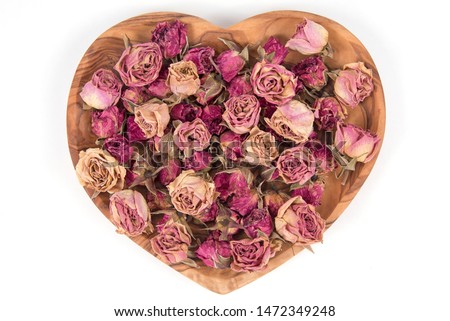 Dried Red and Pink Roses in a Heart shaped plate.