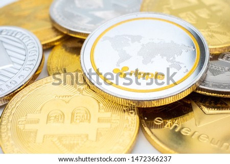 Bunch of Crypto currency coins with various of shiny silver and golden physical cryptocurrencies symbol coins, Bitcoin, Ethereum,. Litecoin, Monero, ripple with focus on XRP Ripple