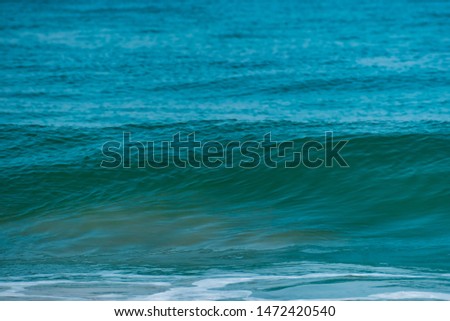 Close up of blue, green sea waves isolated . Morning picture of calm silent ocean waves clean water in summer, tropical beach vacation design template.