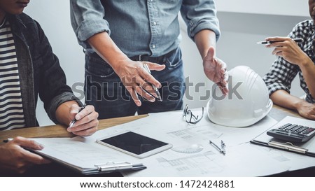Construction and structure concept of Engineer or architect meeting for project working with partner and engineering tools on model building and blueprint in working site, contract for both companies. Royalty-Free Stock Photo #1472424881