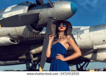 Brunette in a dress at the old airport