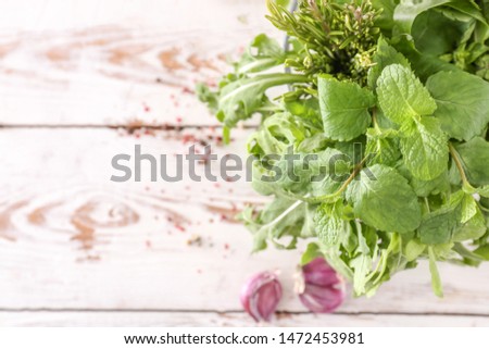 Fresh herbs on white wooden table