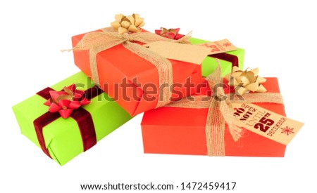 Christmas parcels wrapped in red and green paper with ribbons and bows isolated on a white background