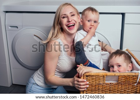 happy family home weekend morning bathroom washing machine.mother and little son in laundry room Washer washed clothes