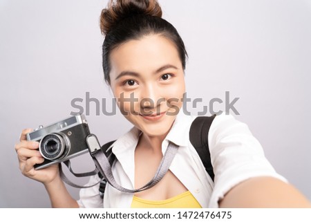 Tourist woman take a selfie smartphone isolated over white background