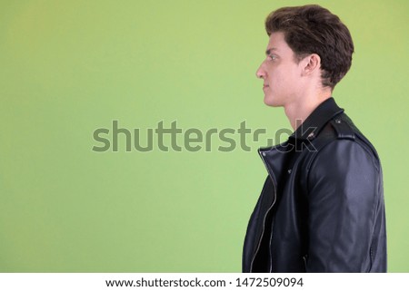Closeup profile view of young handsome rebellious man