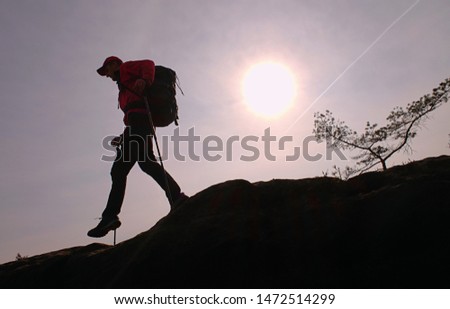 Target of traveler with backpack. Hiker makes trekking trip on mountain. Adventure travel lifestyle concept