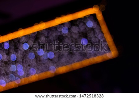 Photo of Christmas signs with bright lights in the bokeh style at an angle, photographed from the bottom up