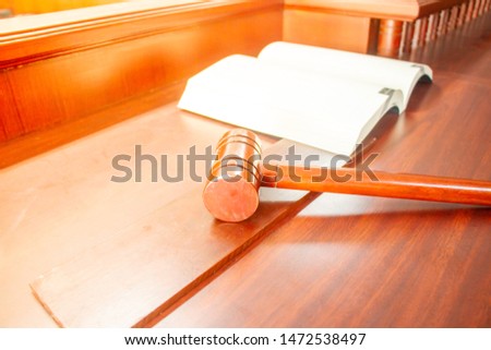 Wooden hammer and book on brown wood table