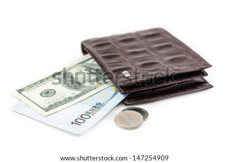 The brown  leather wallet with euro and dollar is photographed on the close-up