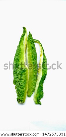 A portrait picture of Bitter gourd slices on white background