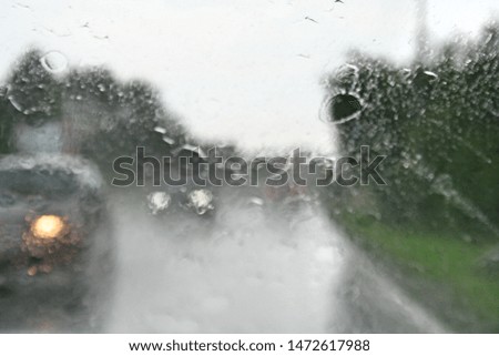 Abstract traffic in raining day. View from car seat. 