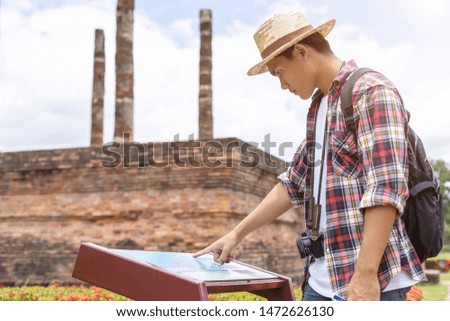 Asian tourist man looking to map in Sukhothai historical park, Northern of Thailand