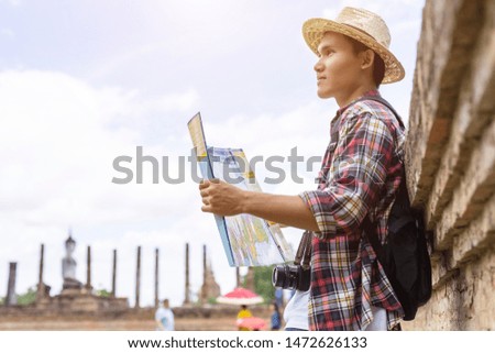 Asian tourist man looking to map in Sukhothai historical park, Northern of Thailand
