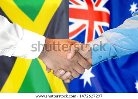 Business handshake on the background of two flags. Men handshake on the background of the Jamaica and Australia flag. Support concept