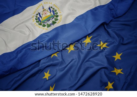 waving colorful flag of european union and flag of el salvador.  