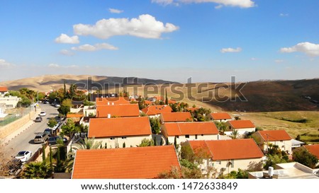 Small town with red rooftops Close to the desert Aerial view
Drone shot of Houses Close to the desert in Israel city of Maale adumim

