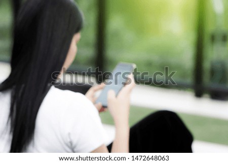 Blurred women using smartphone background