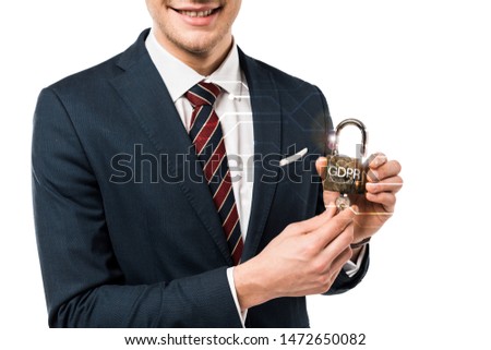 cropped view of happy businessman in suit holding keys and padlock with gdpr lettering on white 