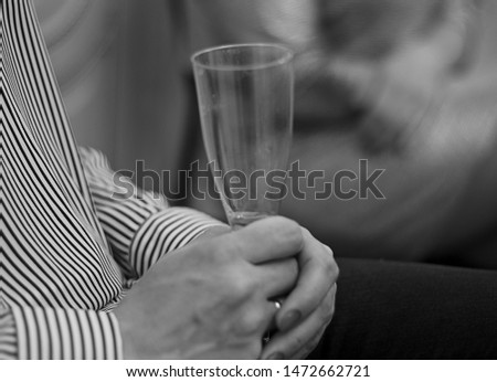 The woman is sad and drinking wine from a glass.