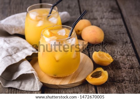Glass of Ripe Peaches or Apricot of Juice on Wooden Background Tasty Cold Apricot Juice Horizontal