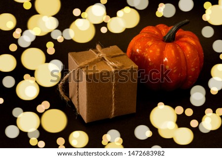 Halloween The concept of festive decor. Halloween gift and pumpkin. Place for text.