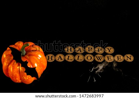 Halloween background. The inscription and the spider. The inscription "happy halloween" on a black background. Place for text.