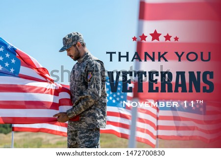 selective focus of man in military uniform and cap standing and touching american flag  with thank you veterans illustration
