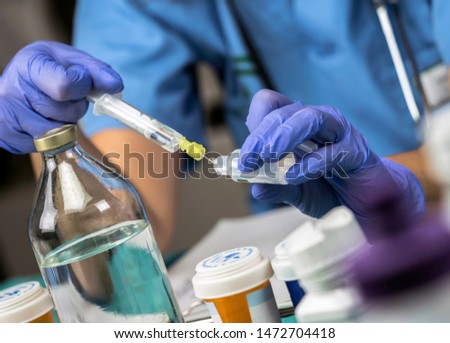 Nurse preparing medication for parenteral nutrition in a hospital, conceptual image Royalty-Free Stock Photo #1472704418