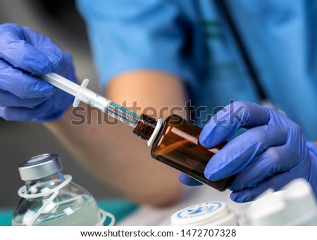 Nurse preparing medication for parenteral nutrition in a hospital, conceptual image Royalty-Free Stock Photo #1472707328