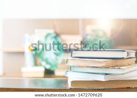 Education concept. Stack of books on table. Blur bookshelf background