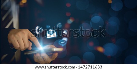 CONTACT US, Hand of a businessman holding a mobile smartphone with the icon. Contact us connection concept with copy space. Royalty-Free Stock Photo #1472711633